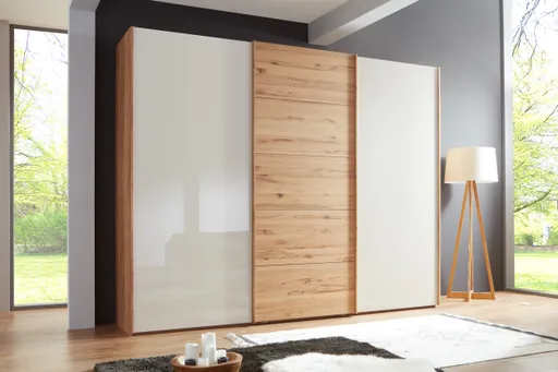 Schwebetürenschrank - B. ca. 300 cm, Astkernbuche Teilmassiv, Mitteltür Massivholz, Glas Champagner 